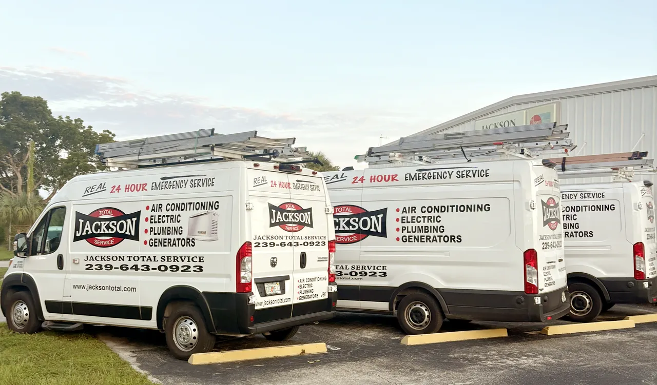 Three Jackson Total Service vans parked outside the Naples shop